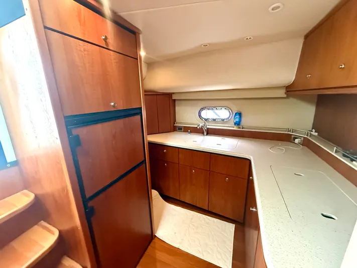 Relentless Yacht Photos Pics 2006 Tiara Yachts 4300 Sovran kitchen with wood cabinetry and modern appliances.