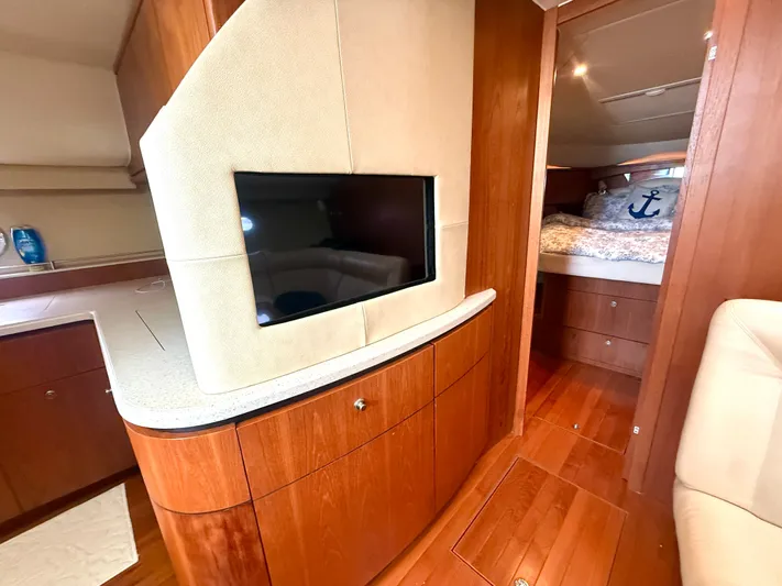 Relentless Yacht Photos Pics Luxurious interior of 2006 Tiara Yachts 4300 Sovran with TV and cozy bedroom.