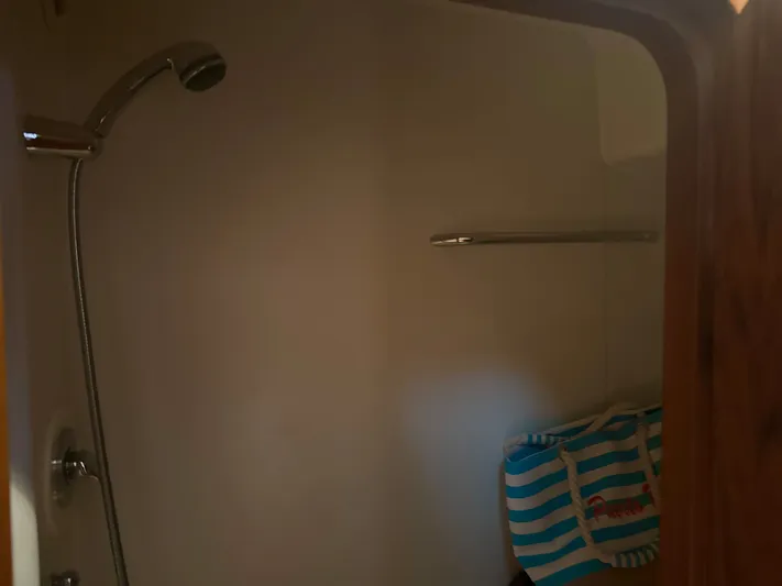 Relentless Yacht Photos Pics Shower area inside 2006 Tiara Yachts 4300 Sovran, featuring a striped bag.