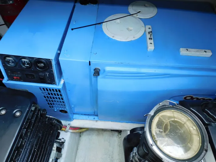 Relentless Yacht Photos Pics Engine compartment of 2006 Tiara Yachts 4300 Sovran, featuring blue machinery and control panel.