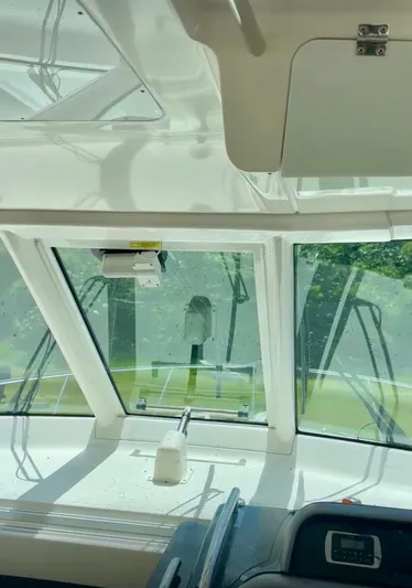  Yacht Photos Pics 2017 Pursuit OS 385 Offshore boat interior with windshield and control panel.