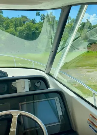  Yacht Photos Pics 2017 Pursuit OS 385 Offshore boat interior with steering wheel and navigation system.