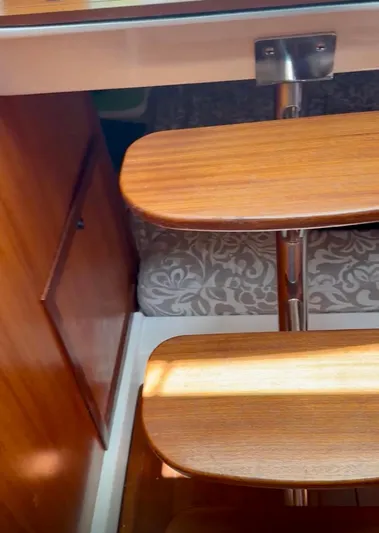  Yacht Photos Pics 2017 Pursuit OS 385 Offshore interior with wooden steps and patterned bedding.