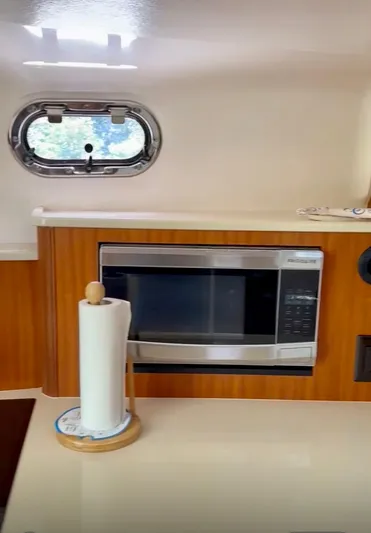  Yacht Photos Pics 2017 Pursuit OS 385 Offshore interior with microwave and paper towel holder.