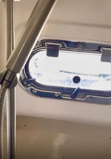  Yacht Photos Pics Porthole view inside 2017 Pursuit OS 385 Offshore boat, showcasing sleek interior design.