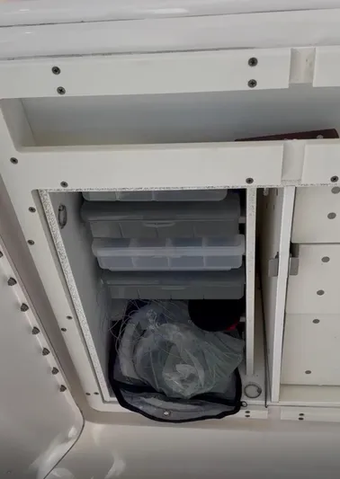  Yacht Photos Pics Storage compartment on a 2017 Pursuit OS 385 Offshore boat with organized tackle boxes.
