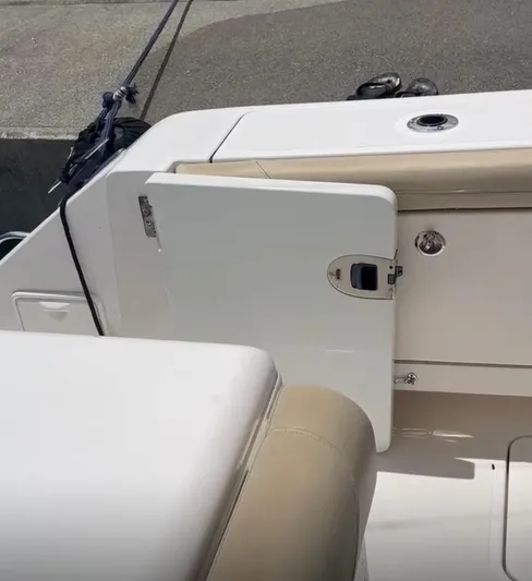  Yacht Photos Pics 2017 Pursuit OS 385 Offshore boat interior with beige seating and storage compartment.