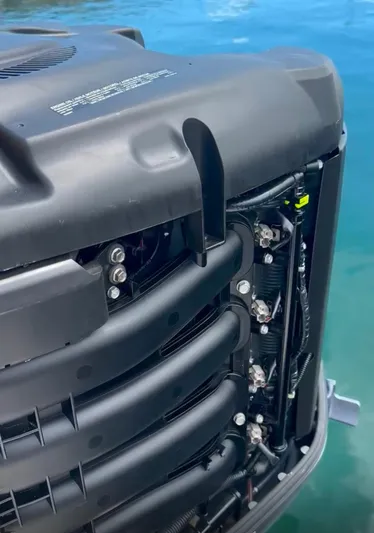  Yacht Photos Pics Close-up of a 2017 Pursuit OS 385 Offshore engine near water.