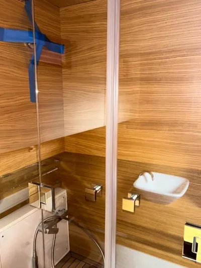  Yacht Photos Pics 2023 De Antonio Yachts D42 Open bathroom with modern wood paneling and sleek fixtures.