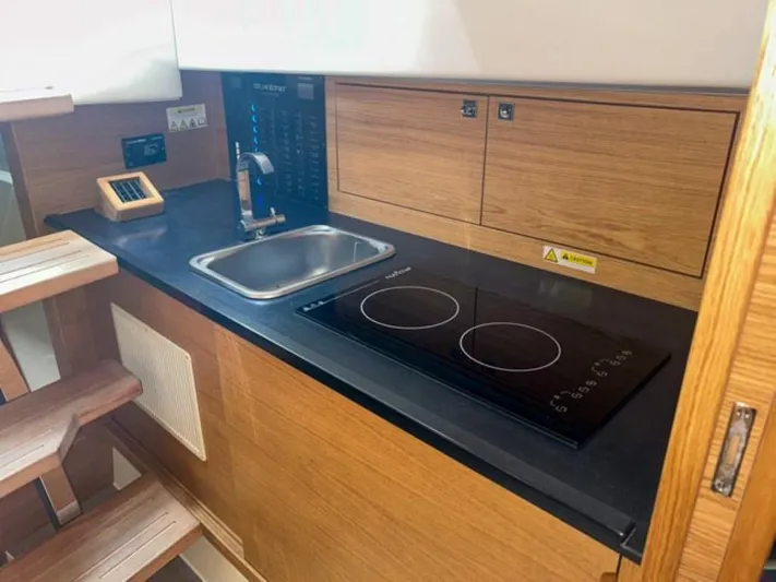  Yacht Photos Pics 2023 De Antonio Yachts D42 Open kitchen with sink and electric stove.