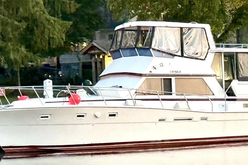  Yacht Photos Pics 1987 Viking 44 Motor Yacht docked, surrounded by lush greenery.