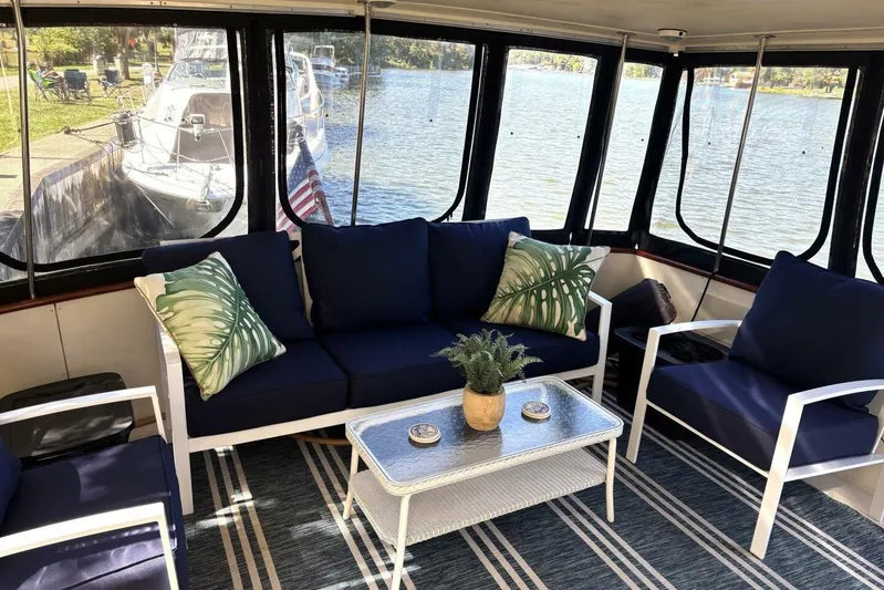  Yacht Photos Pics Cozy interior of 1987 Viking 44 Motor Yacht with blue seating and lake view.