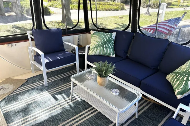  Yacht Photos Pics Cozy seating area on 1987 Viking 44 Motor Yacht with blue cushions and decorative pillows.