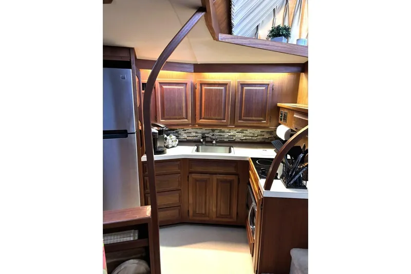  Yacht Photos Pics 1987 Viking 44 Motor Yacht kitchen with wooden cabinets and modern appliances.