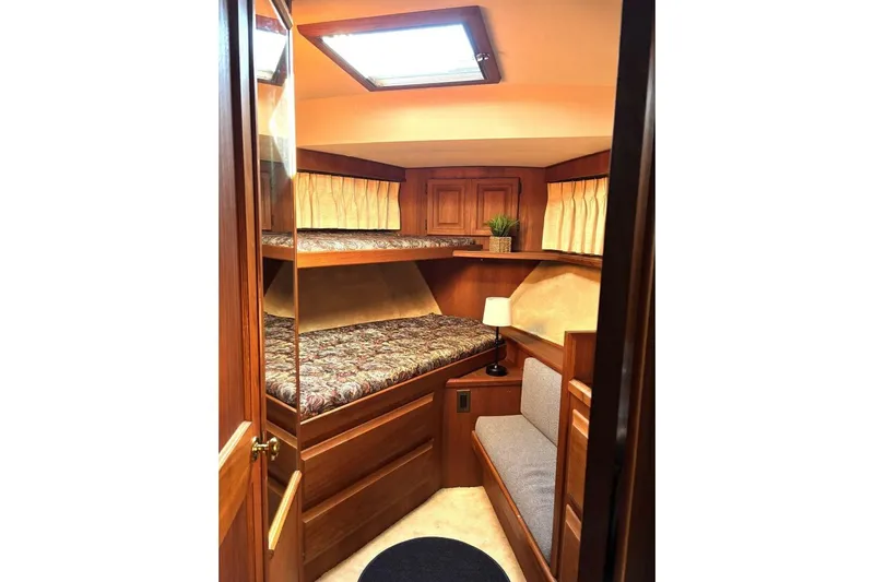  Yacht Photos Pics Cozy cabin interior of 1987 Viking 44 Motor Yacht with wooden furnishings and bunk beds.