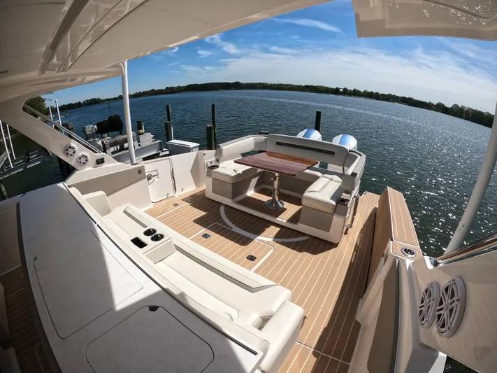  Yacht Photos Pics 2024 Tiara Yachts 43 LS luxury deck with seating, table, and scenic water view.