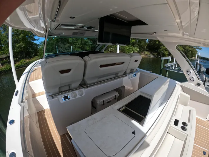  Yacht Photos Pics 2024 Tiara Yachts 43 LS interior with seating, TV, and sleek design.