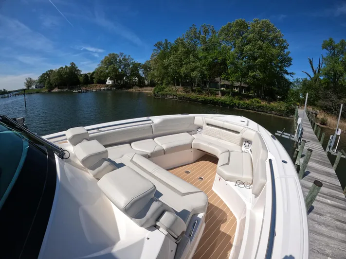  Yacht Photos Pics 2024 Tiara Yachts 43 LS with spacious seating, docked by a scenic waterfront.