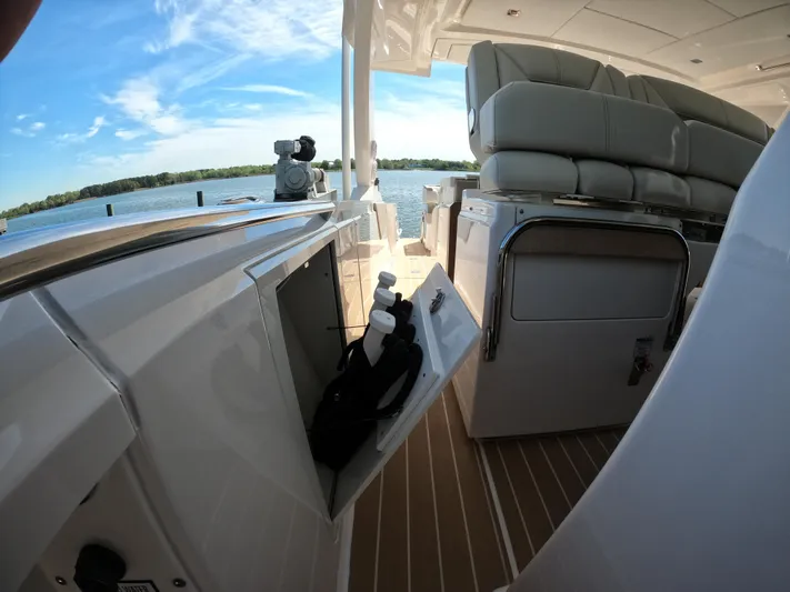  Yacht Photos Pics 2024 Tiara Yachts 43 LS interior with seating and storage, overlooking serene waters.