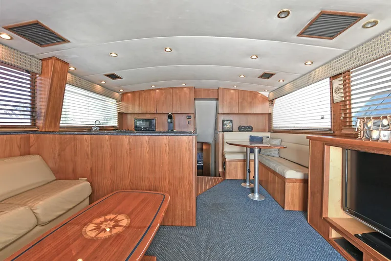 Journey Yacht Photos Pics Luxurious interior of 2000 Torres 48 Enclosed Bridge yacht with wood finishes and modern amenities.