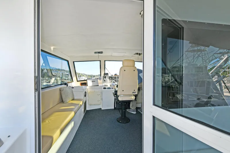 Journey Yacht Photos Pics Interior of 2000 Torres 48 Enclosed Bridge boat with seating and helm.