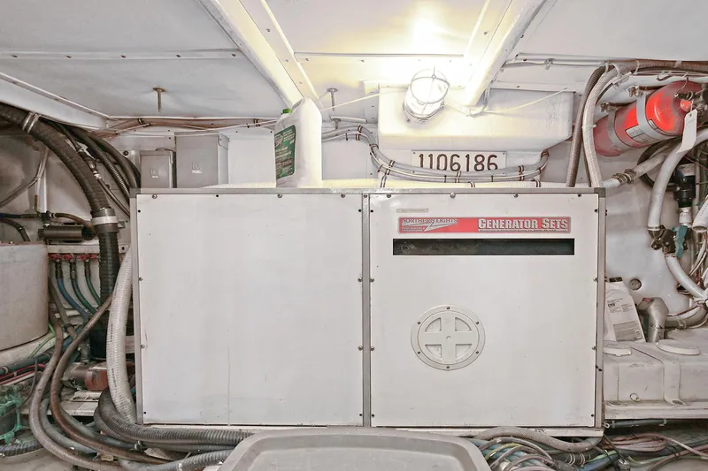 Journey Yacht Photos Pics Engine room of 2000 Torres 48 Enclosed Bridge with generator and wiring.