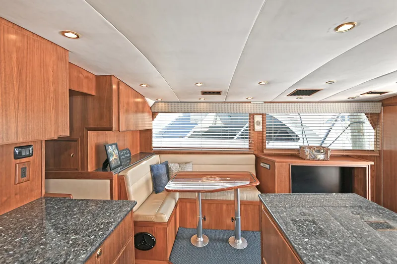 Journey Yacht Photos Pics Interior of 2000 Torres 48 Enclosed Bridge yacht with wood finish and seating area.