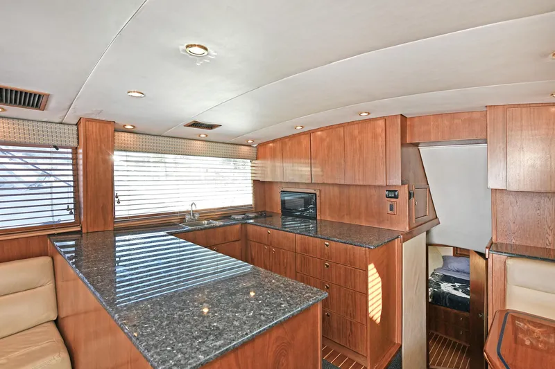 Journey Yacht Photos Pics Luxurious kitchen interior of 2000 Torres 48 Enclosed Bridge yacht with granite countertops.