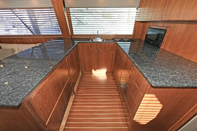 Journey Yacht Photos Pics Luxurious kitchen interior of 2000 Torres 48 Enclosed Bridge yacht with granite countertops.