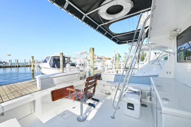 Journey Yacht Photos Pics 2000 Torres 48 Enclosed Bridge yacht docked at marina, featuring spacious deck and seating.