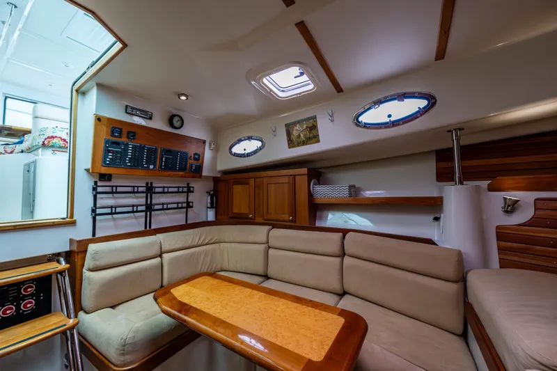 Ha Kin Yacht Photos Pics Interior of 2008 Back Cove 33 yacht with cozy seating and wooden accents.