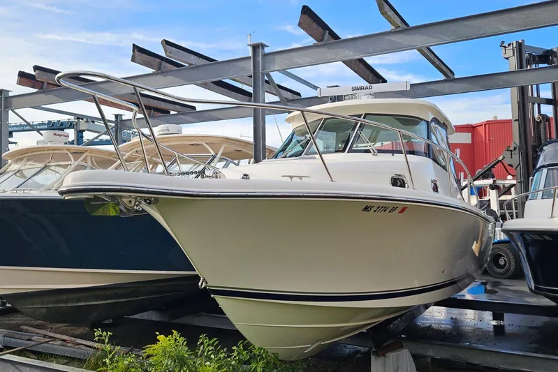  Yacht Photos Pics 2013 Pursuit OS 315 Offshore boat in storage, surrounded by other vessels.