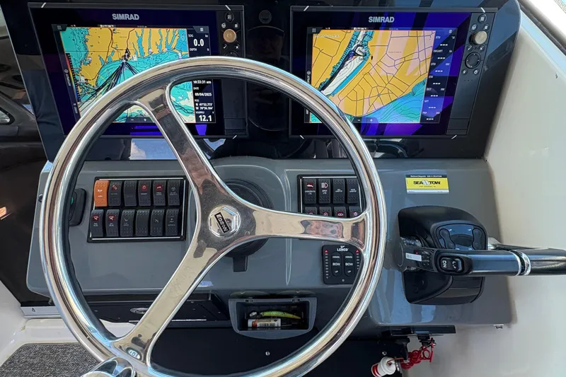  Yacht Photos Pics Steering console of 2013 Pursuit OS 315 Offshore with dual Simrad navigation displays.