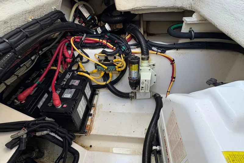 Yacht Photos Pics 2013 Pursuit OS 315 Offshore engine compartment with batteries and wiring.