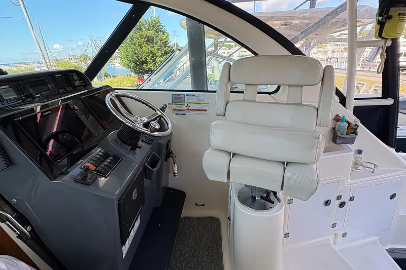  Yacht Photos Pics 2013 Pursuit OS 315 Offshore helm with steering wheel and captain's chair.