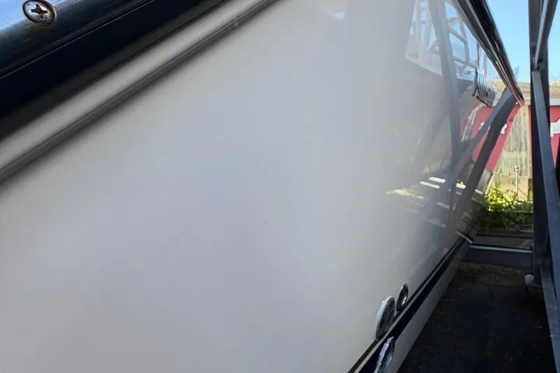  Yacht Photos Pics Close-up of a 2013 Pursuit OS 315 Offshore boat hull, showcasing sleek design.