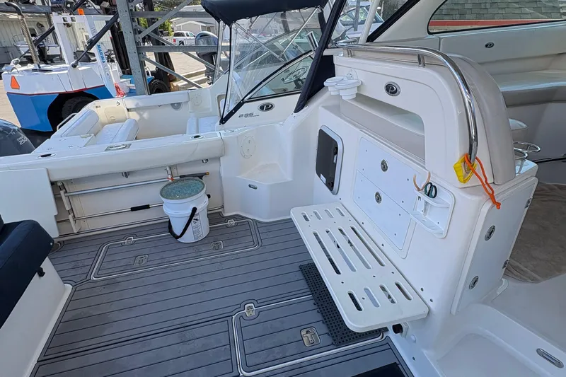  Yacht Photos Pics 2013 Pursuit OS 315 Offshore boat interior with seating and storage compartments.