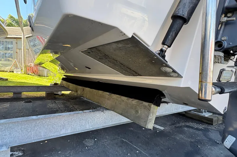  Yacht Photos Pics 2013 Pursuit OS 315 Offshore boat on trailer, showing hull and trim tabs.