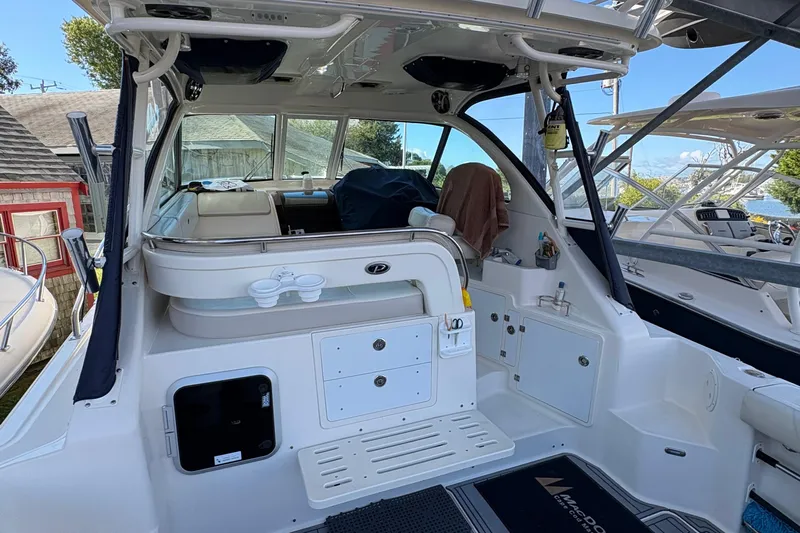  Yacht Photos Pics 2013 Pursuit OS 315 Offshore boat interior with seating and storage compartments.