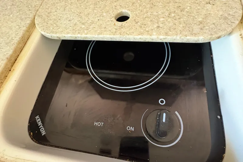  Yacht Photos Pics Kenyon stove on 2013 Pursuit OS 315 Offshore boat, covered with countertop.