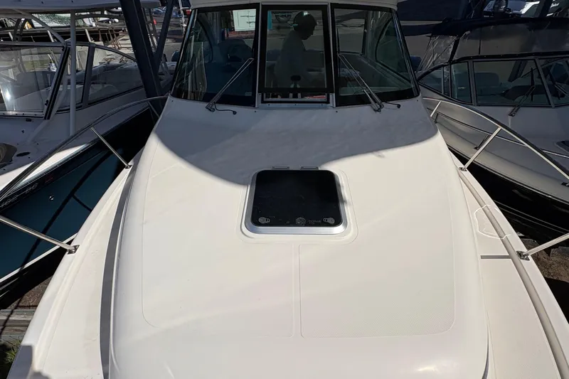  Yacht Photos Pics 2013 Pursuit OS 315 Offshore boat docked, showcasing front deck and windshield.