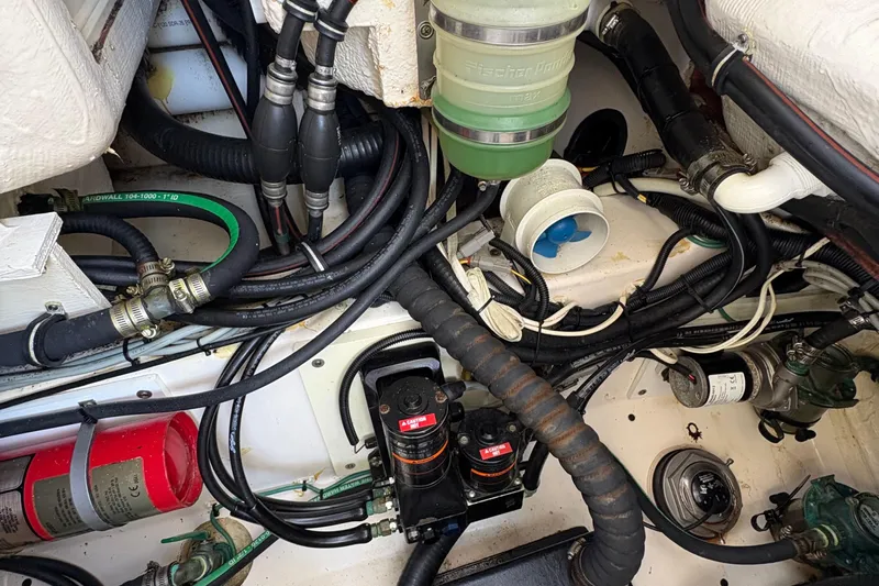  Yacht Photos Pics Engine compartment of a 2013 Pursuit OS 315 Offshore boat, showing hoses and components.