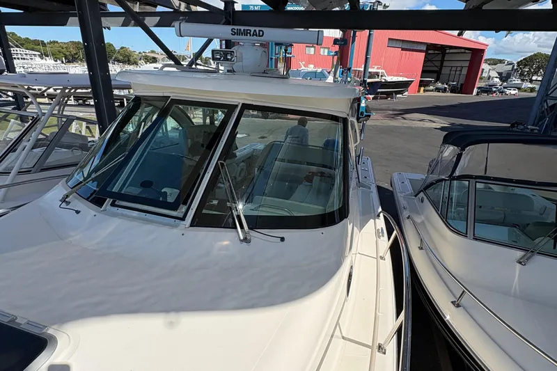  Yacht Photos Pics 2013 Pursuit OS 315 Offshore boat docked, featuring Simrad equipment and sleek design.