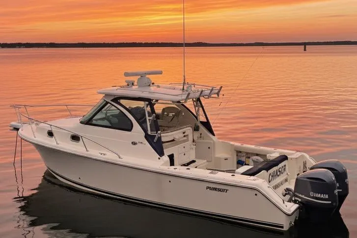  Yacht Photos Pics 2013 Pursuit OS 315 Offshore boat on calm water at sunset.