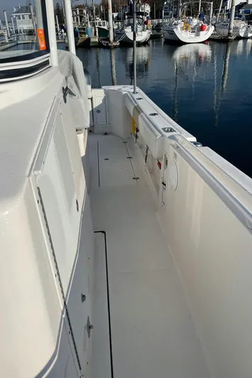  Yacht Photos Pics 2015 Edgewater 280CC boat docked, showcasing spacious deck and sleek design.