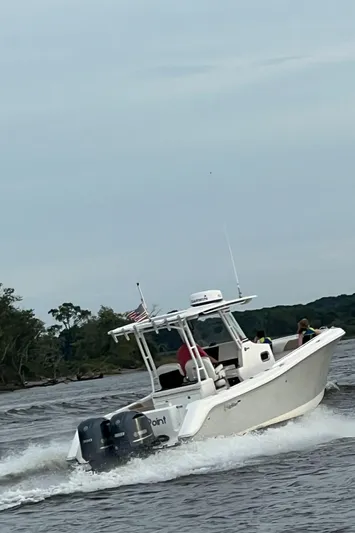  Yacht Photos Pics 2015 Edgewater 280CC boat cruising on a river with trees in the background.