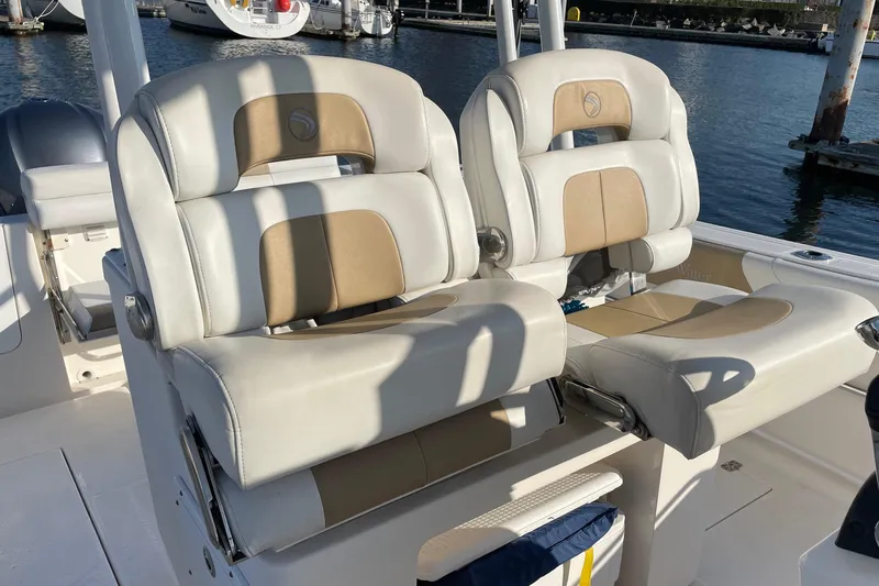  Yacht Photos Pics 2015 Edgewater 280CC boat seats, beige and white, docked at marina.