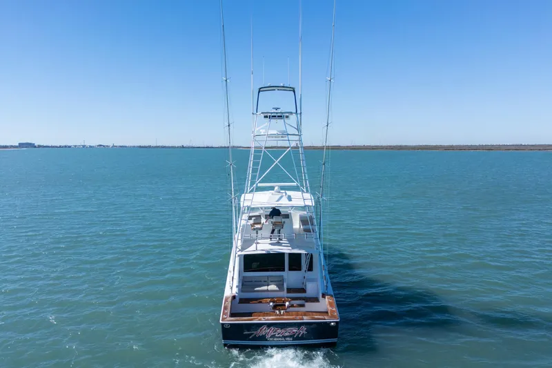 Yacht Photos Pics 2002 Viking Convertible yacht cruising on open water under clear blue skies.