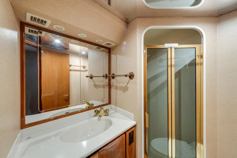  Yacht Photos Pics Luxurious bathroom in 2002 Viking Convertible yacht with shower and vanity.