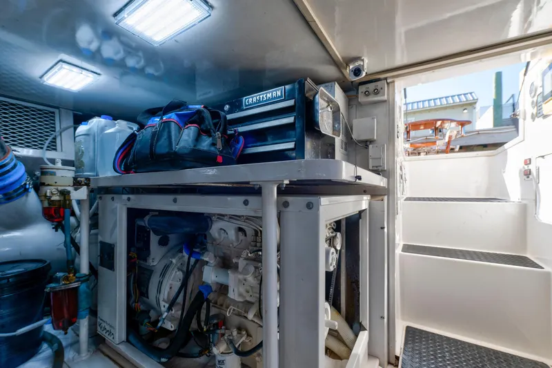  Yacht Photos Pics Engine room of a 2002 Viking Convertible boat with tools and equipment.